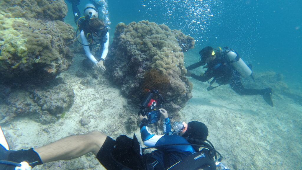 A scuba diver taking a picture of another scuba diver