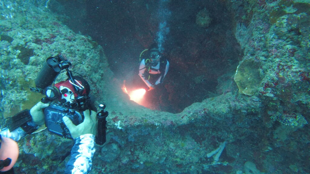 A scuba diver taking a picture of another scuba diver