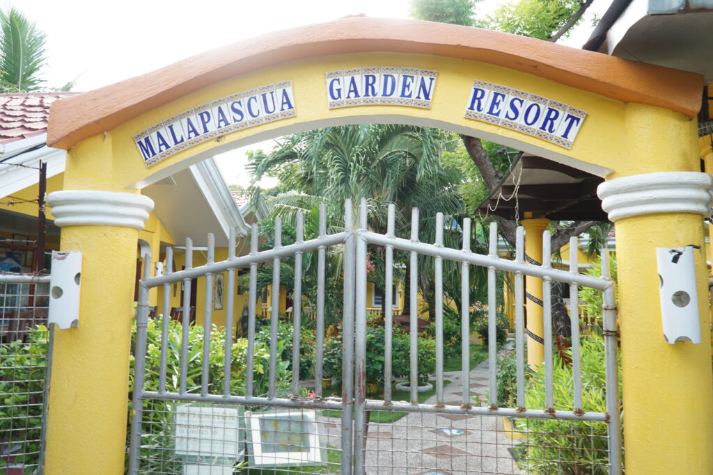 A gate with sign malapascua garden resort
