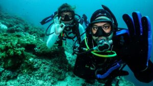 two scuba divers taking a picture