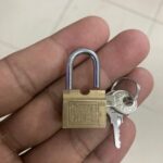 small padlock in a palm of hand.