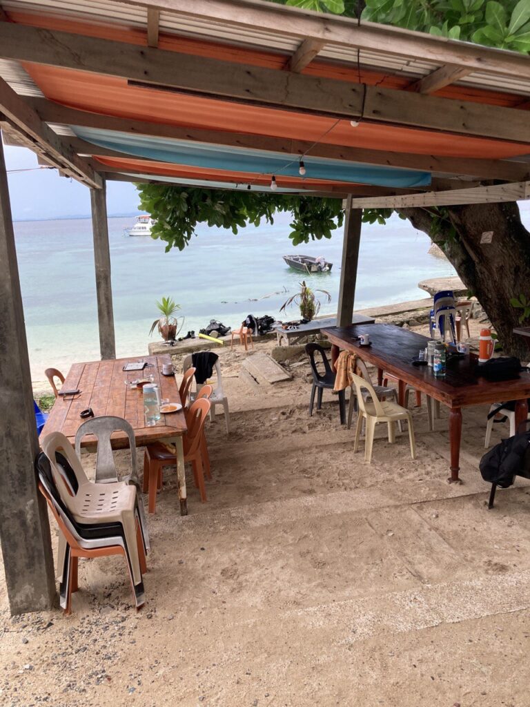 tables and chairs facing the beach