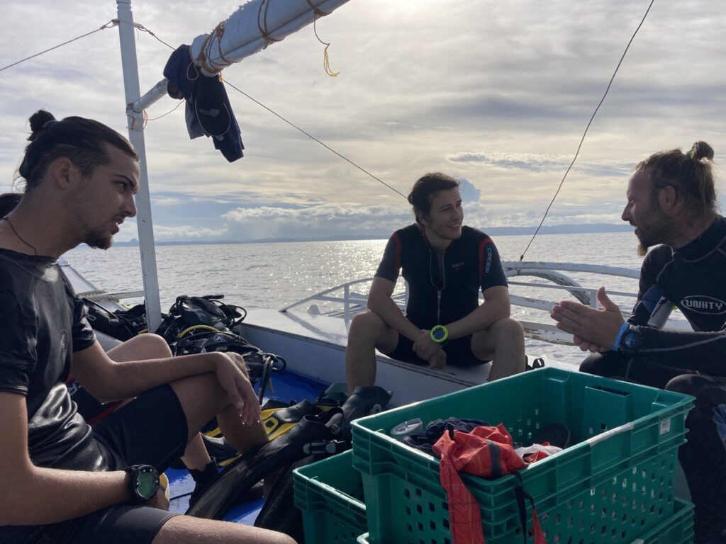 3 men on a boat talking