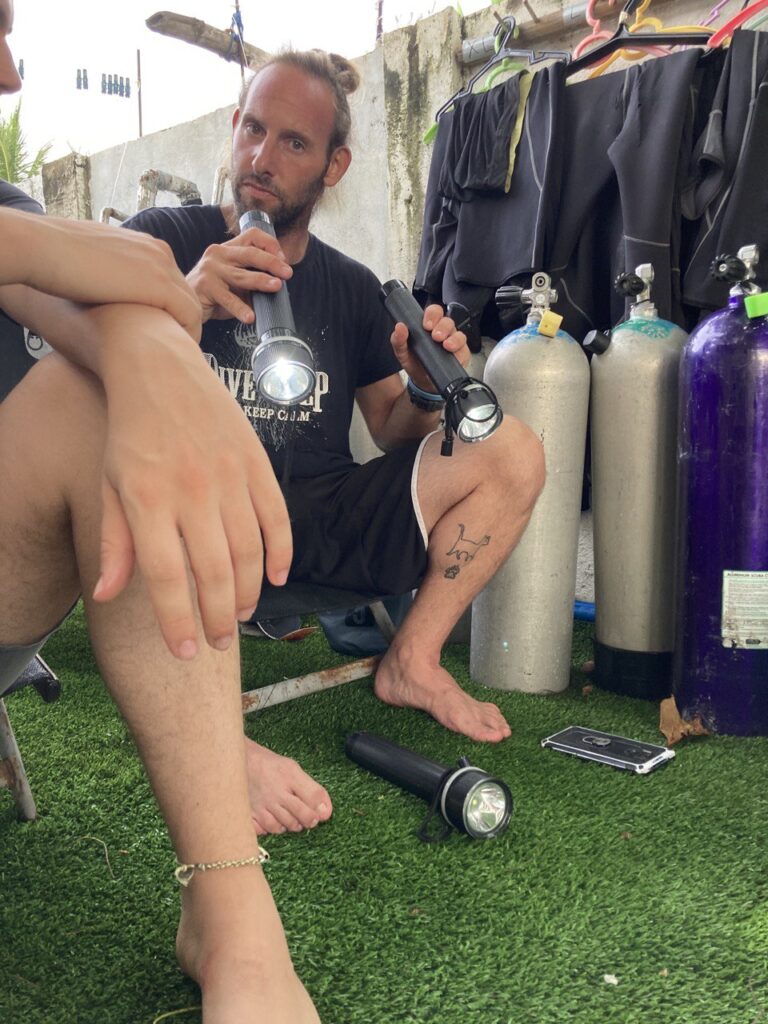 A man holding 2 flashlights