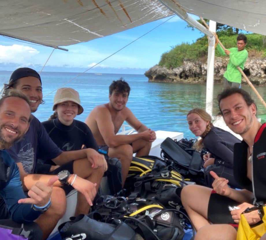 seven people taking picture on a boat