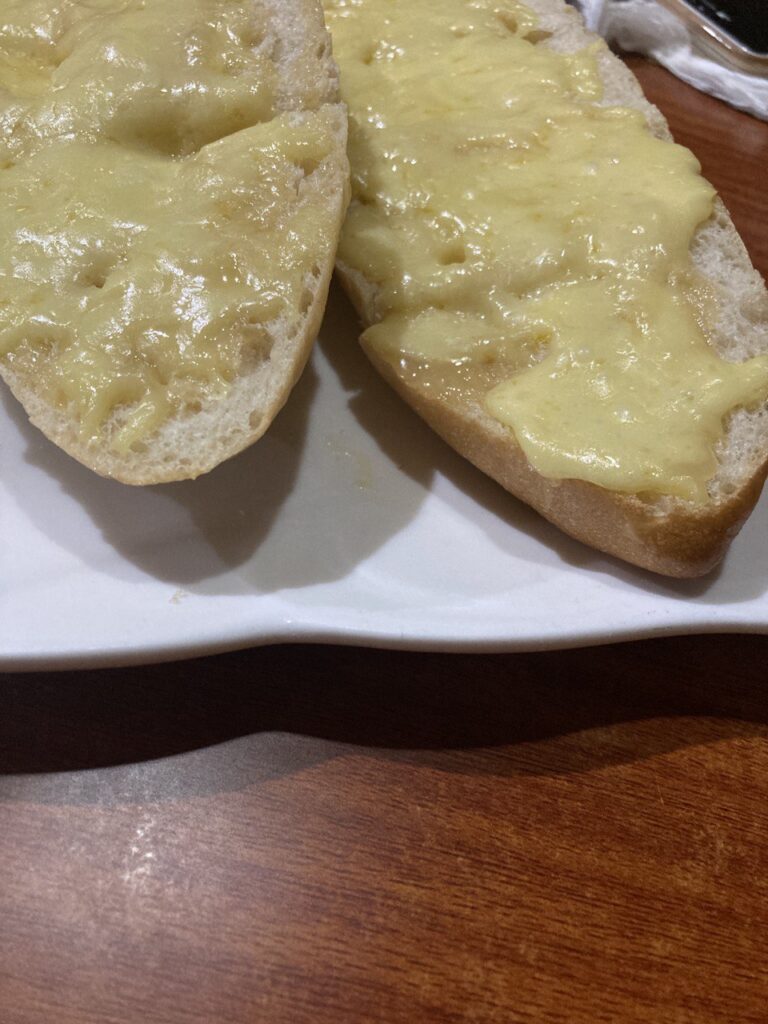 french bread with garlic and melted cheese on top.