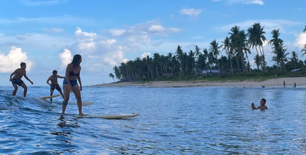 three people surfing