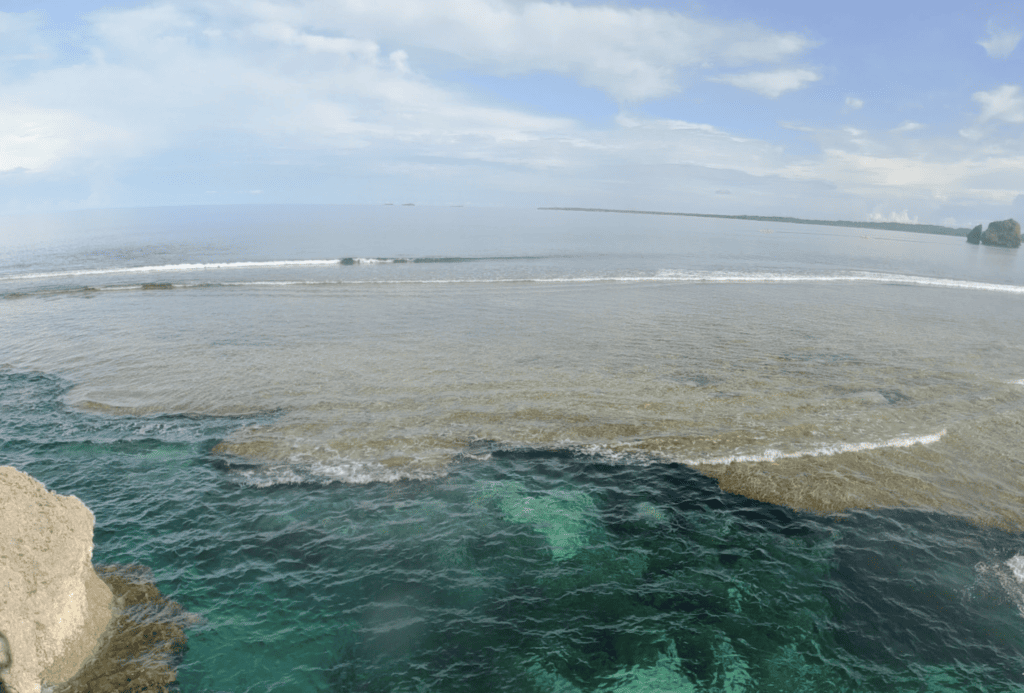 A reef with a gaping hole that trapped the seawater to make a rock pool.